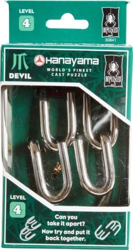 Devil hanayama cast metal puzzle assembled on a work bench